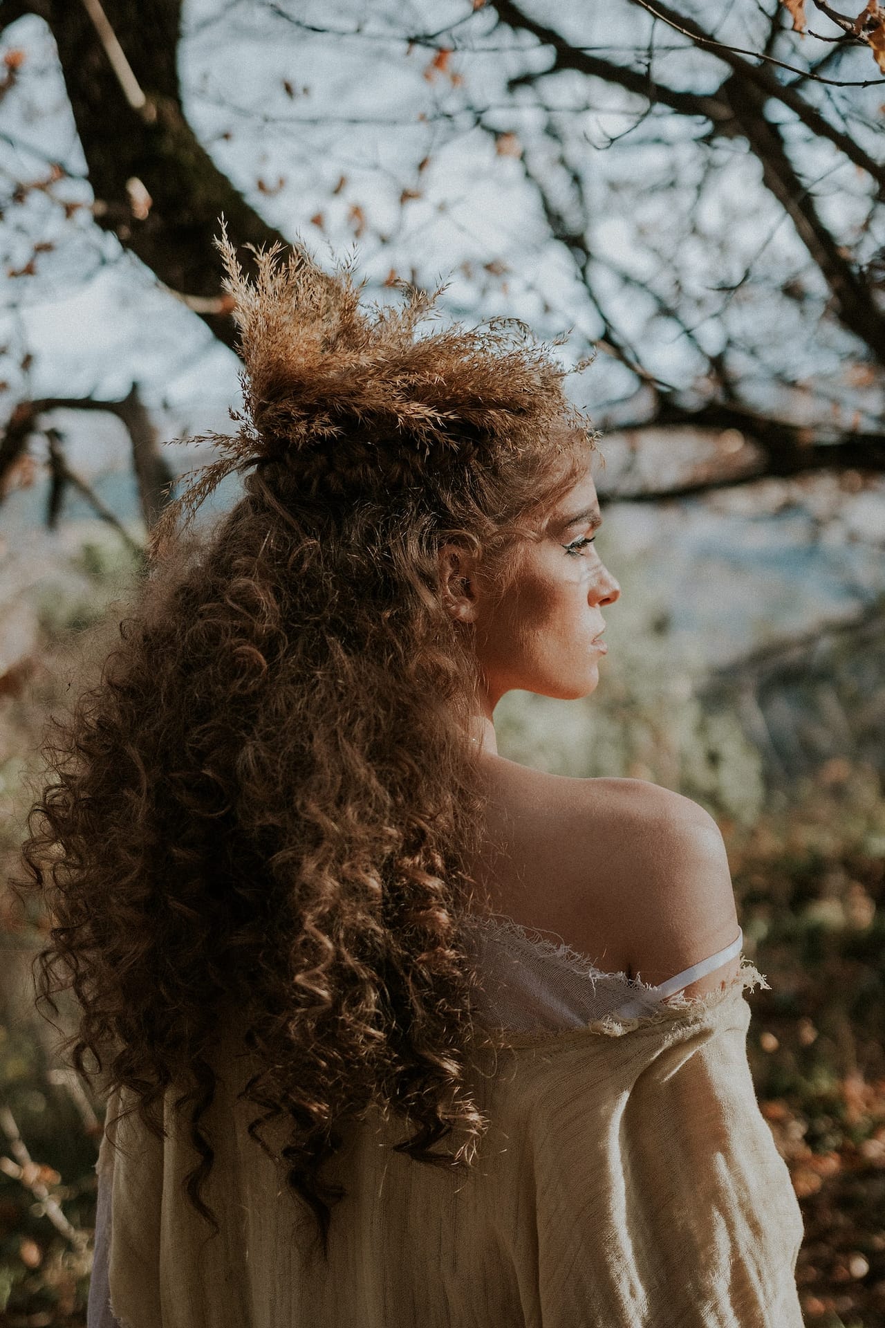 Curly haired princess girl in the sunset