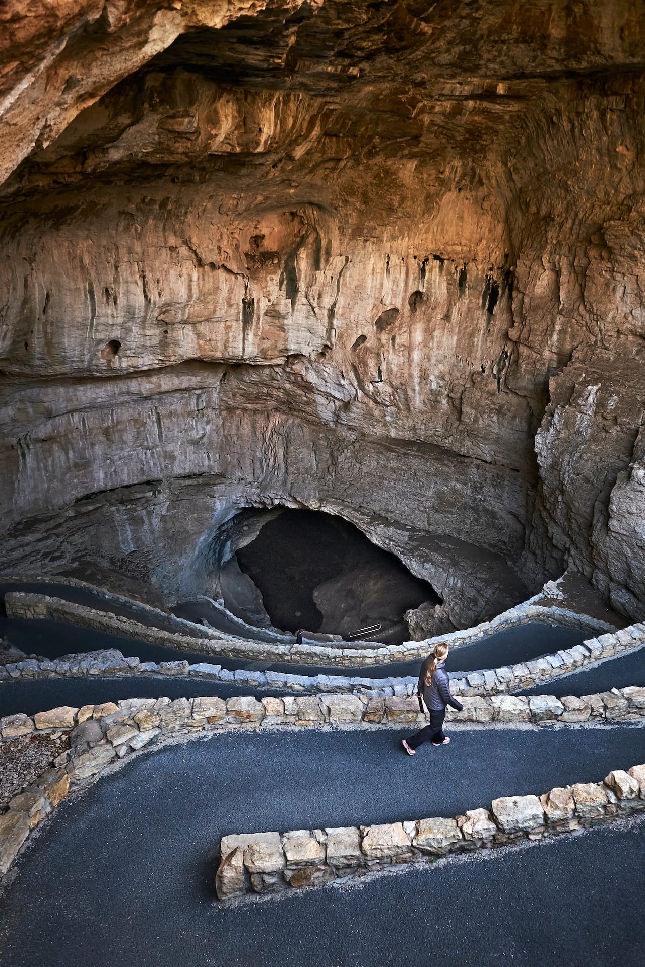 Woman walking downhill to cave, Carlsbad, New Mexico