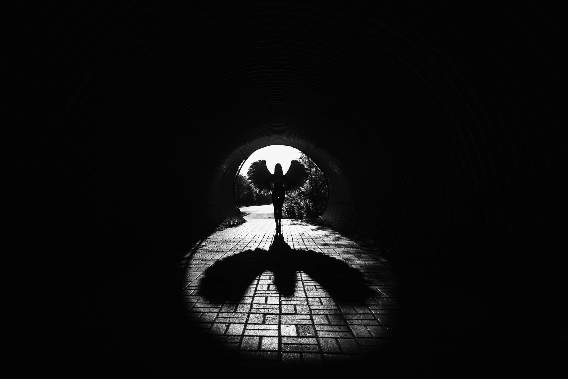 Angel silhouette with shadow in the tunnel